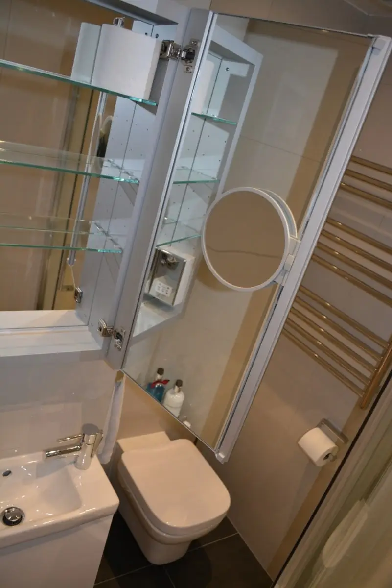 Handmade shelving unit, a sink and a toilet Handmade shelving unit, a sink and a toilet